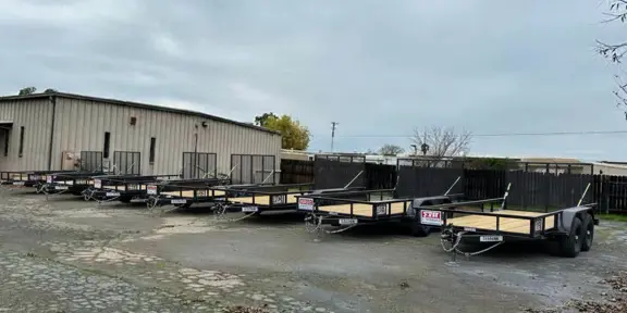 DW Landscaping Trailers lined up in the yard at I-5 Trailer Store